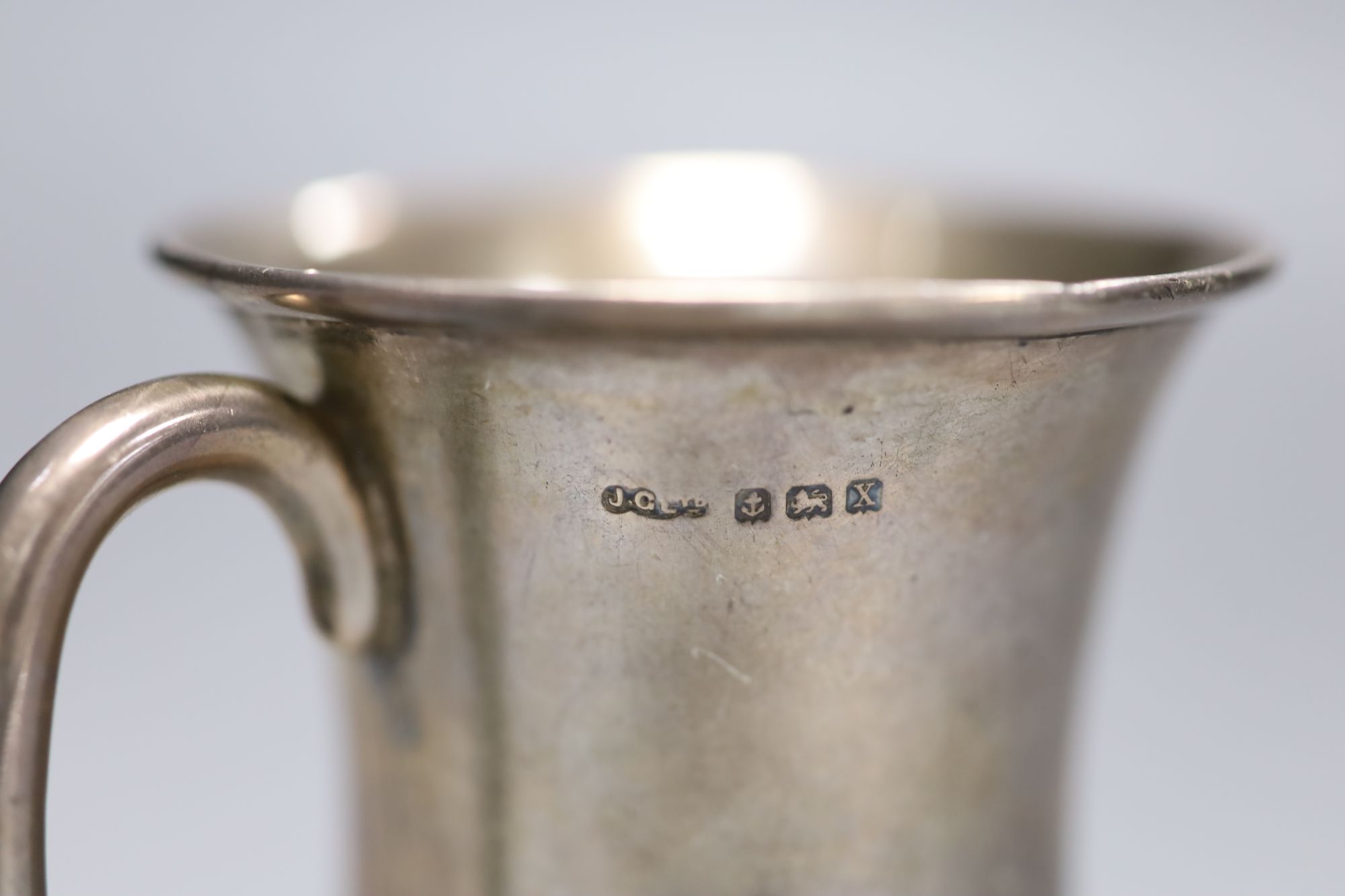 A George V silver waiter, London, 1919, a silver mug and a modern silver wine coaster,